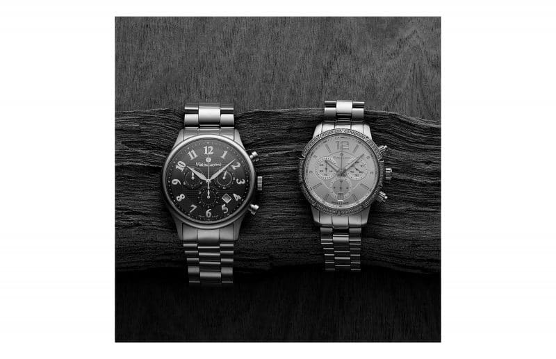 Zwei Herren-Armbanduhren auf einem Holz. Metallarmband. Mathieu Legrand
